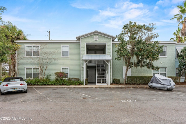 3434 Blanding Blvd Unit 206, Jacksonville, FL 32210 - view of building exterior with stairs and uncovered parking