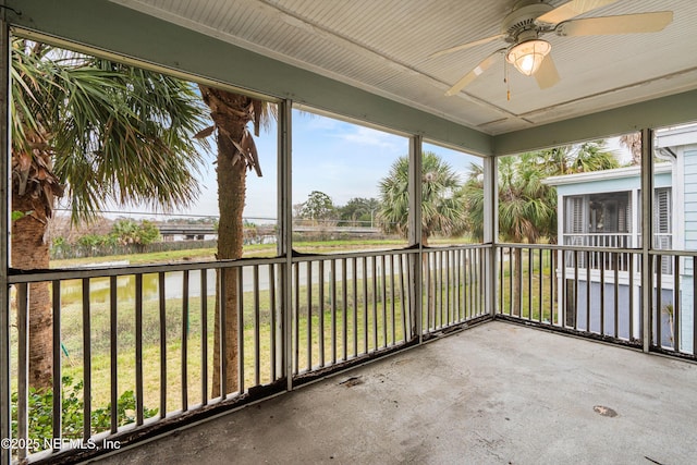 unfurnished sunroom featuring a water view