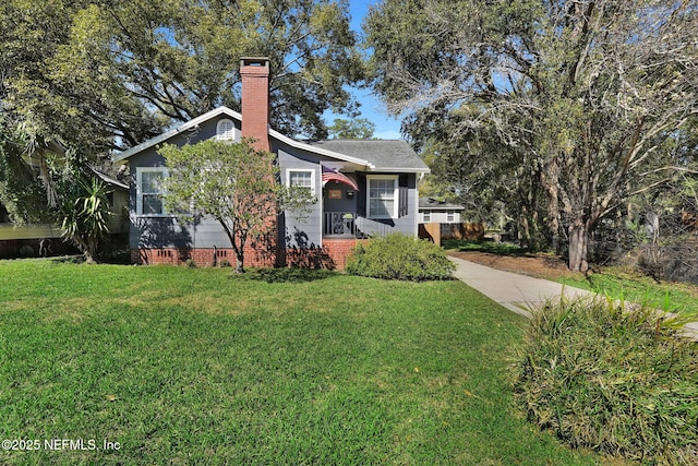 view of front facade featuring crawl space, a chimney, and a front lawn