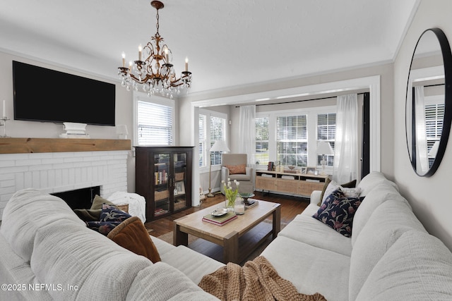 living room featuring a fireplace, wood finished floors, and crown molding