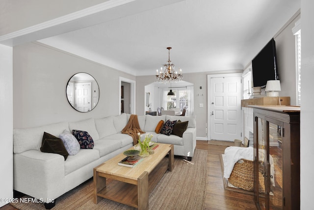 living room featuring an inviting chandelier and wood finished floors