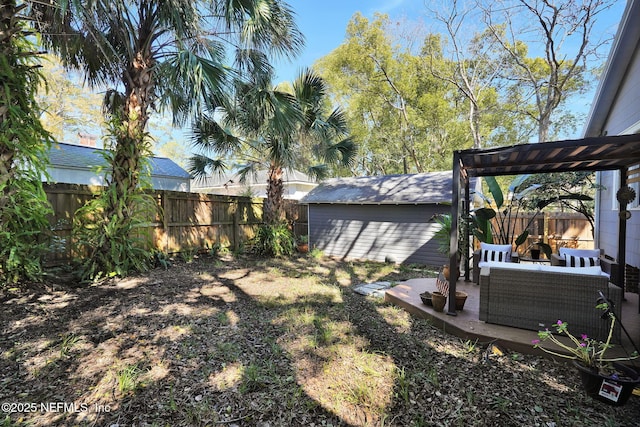 view of yard with an outbuilding, a patio area, a fenced backyard, and an outdoor hangout area