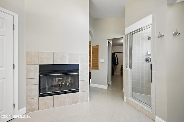 interior space featuring a tiled fireplace and baseboards