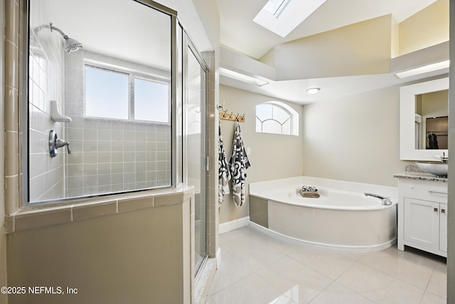 full bath featuring vanity, a stall shower, a bath, tile patterned floors, and lofted ceiling with skylight