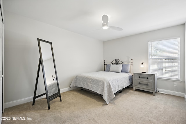 bedroom featuring ceiling fan, baseboards, and light colored carpet