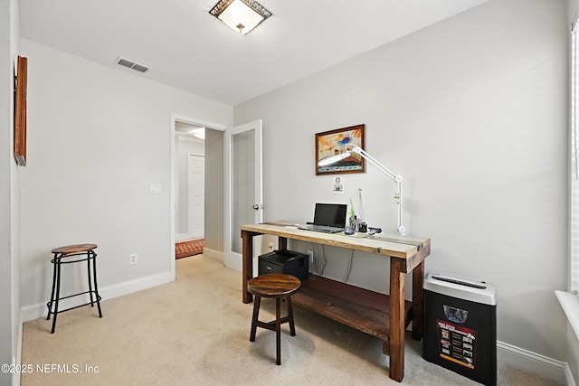 office area with light carpet, visible vents, and baseboards