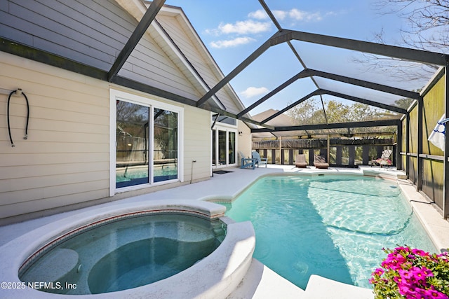 view of pool with a pool with connected hot tub, a lanai, and a patio