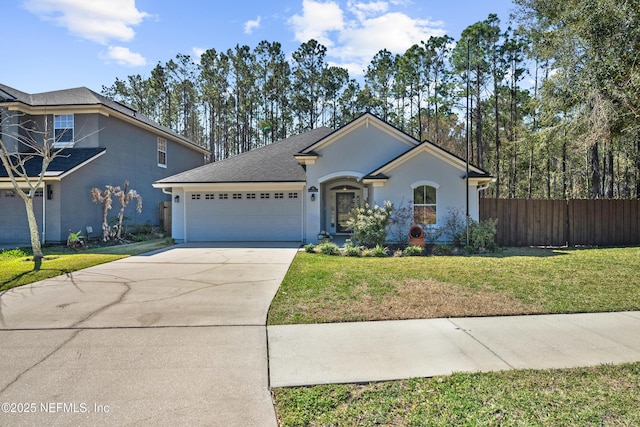 ranch-style house featuring fence, concrete driveway, a front yard, stucco siding, and an attached garage