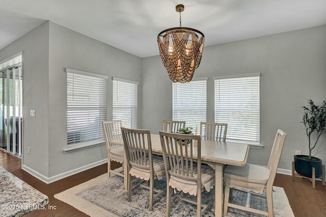 dining space featuring a healthy amount of sunlight, an inviting chandelier, and baseboards