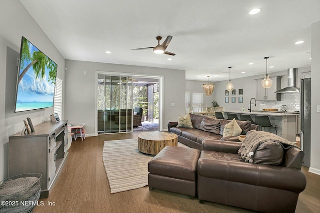 living room with ceiling fan, baseboards, dark wood finished floors, and recessed lighting