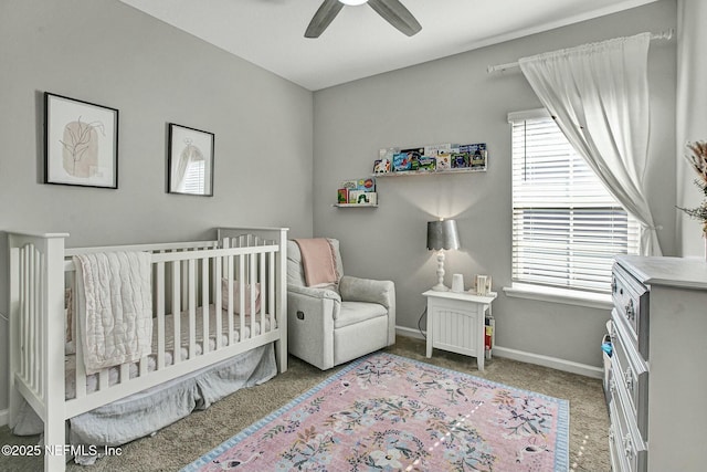 bedroom with carpet, multiple windows, a crib, and baseboards