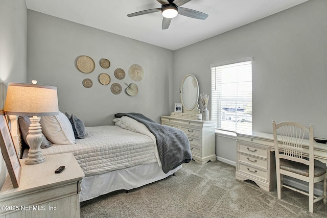 bedroom with ceiling fan, baseboards, and light colored carpet