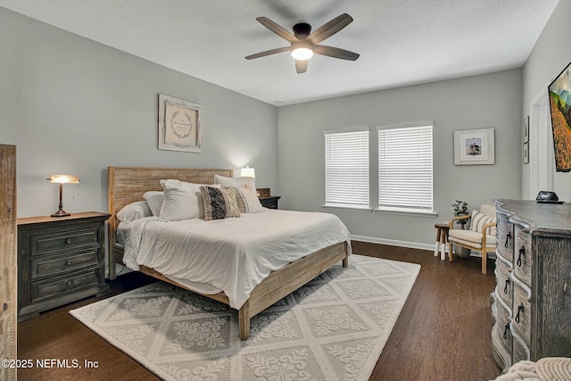 bedroom featuring a ceiling fan, baseboards, and dark wood-type flooring