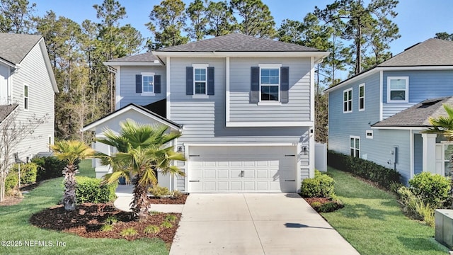 traditional home featuring a garage, concrete driveway, and a front lawn