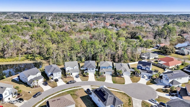 bird's eye view featuring a water view, a residential view, and a view of trees