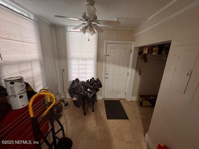 unfurnished dining area with crown molding and ceiling fan