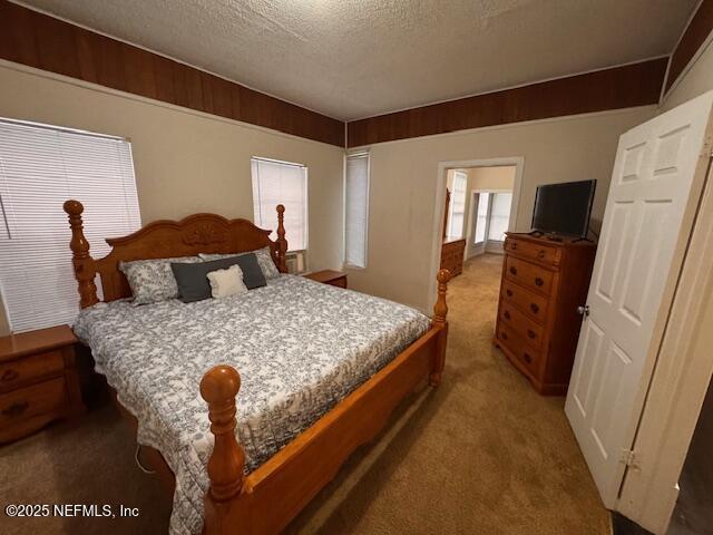 bedroom with a textured ceiling and carpet flooring