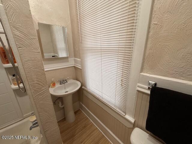 bathroom with toilet and wood finished floors