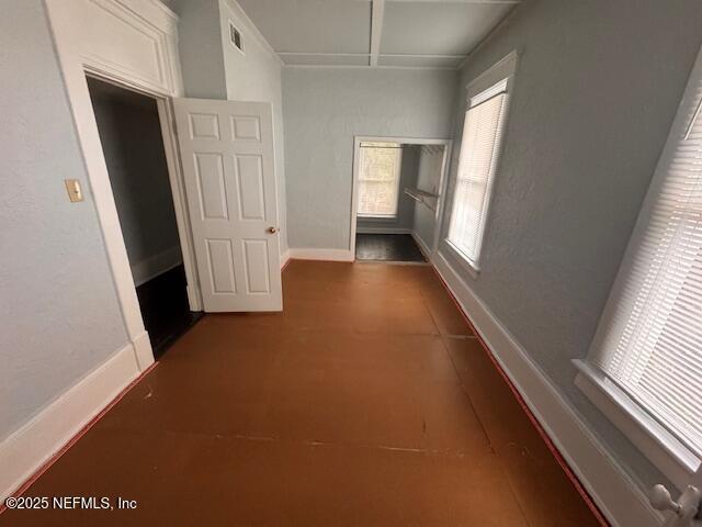 hall with visible vents and baseboards