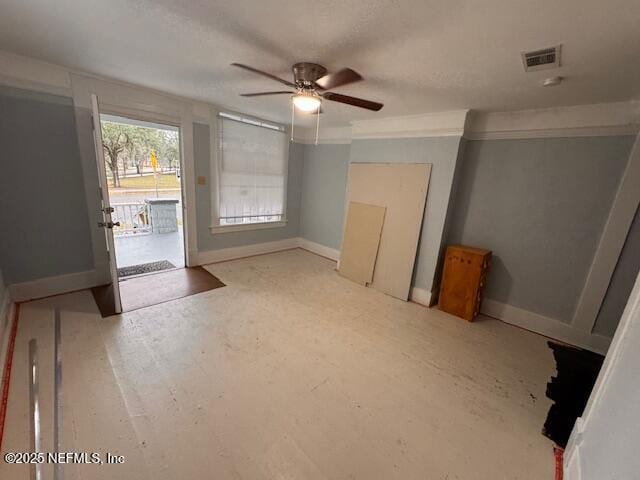 interior space featuring access to outside, visible vents, ceiling fan, and baseboards