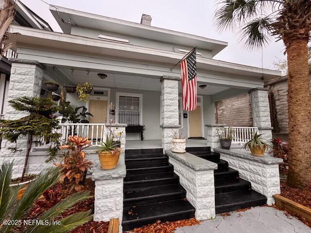 doorway to property featuring covered porch