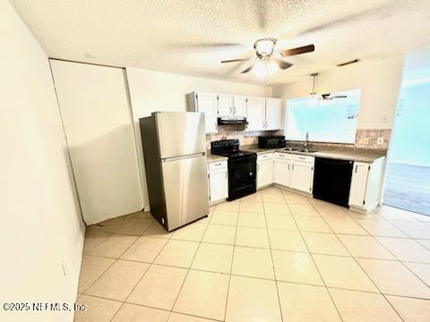 kitchen featuring a sink, white cabinetry, a ceiling fan, light countertops, and black appliances