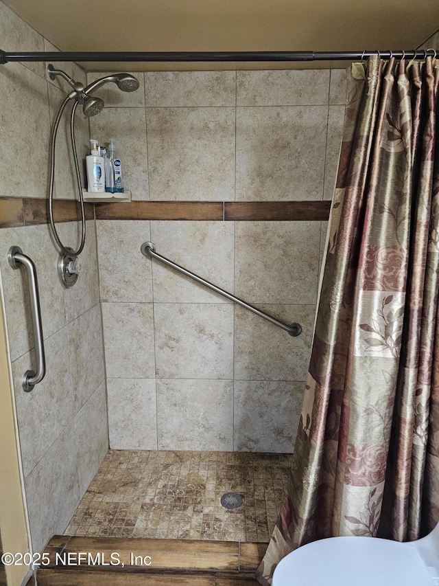 full bath with a shower stall