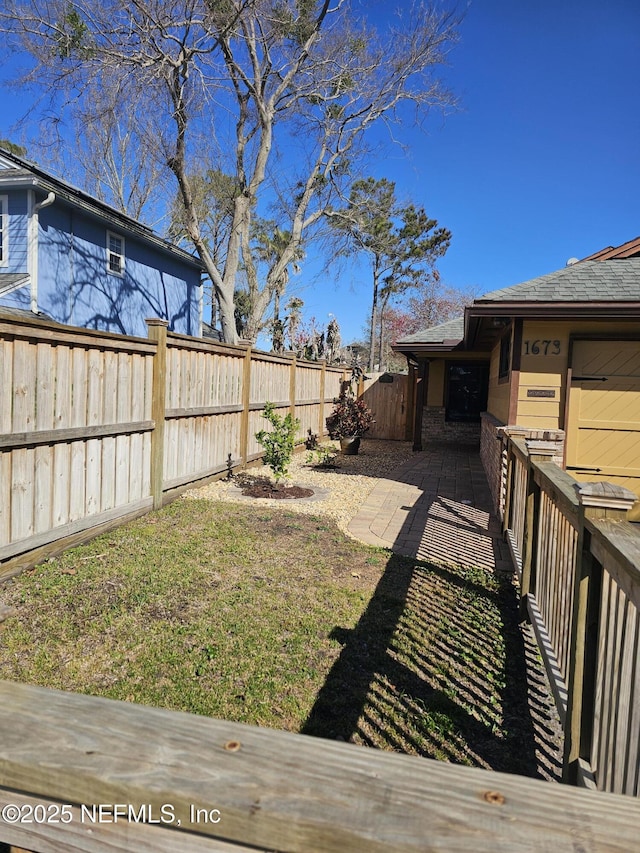 view of yard with a patio and a fenced backyard