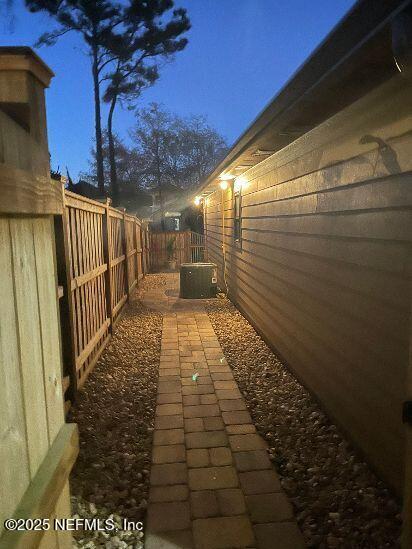 view of property exterior with a fenced backyard and central AC unit