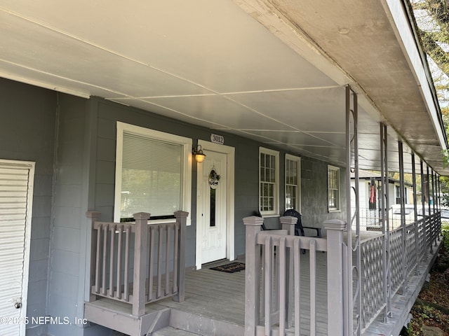 view of exterior entry with a porch