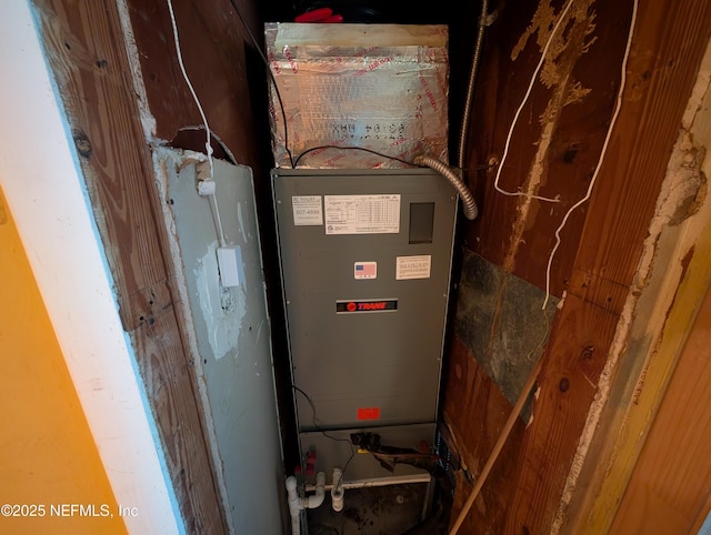 utility room featuring heating unit