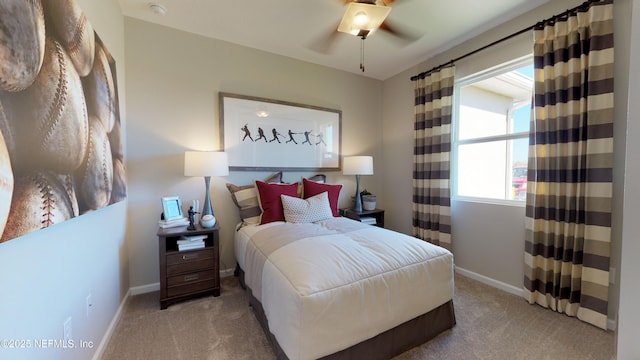 bedroom with light colored carpet, ceiling fan, and baseboards