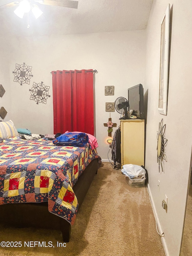 bedroom with carpet, ceiling fan, and baseboards