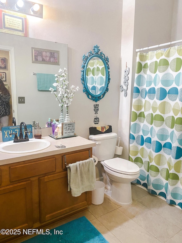 full bathroom with toilet, tile patterned flooring, and vanity