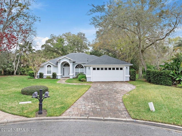 single story home featuring decorative driveway, roof with shingles, stucco siding, a front yard, and a garage