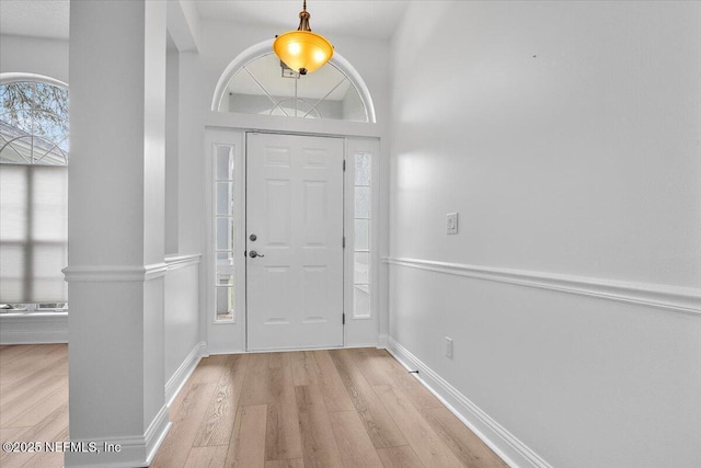 foyer featuring light wood finished floors and baseboards