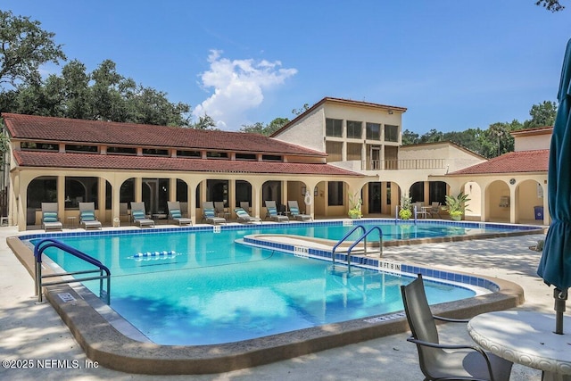 community pool with a patio area