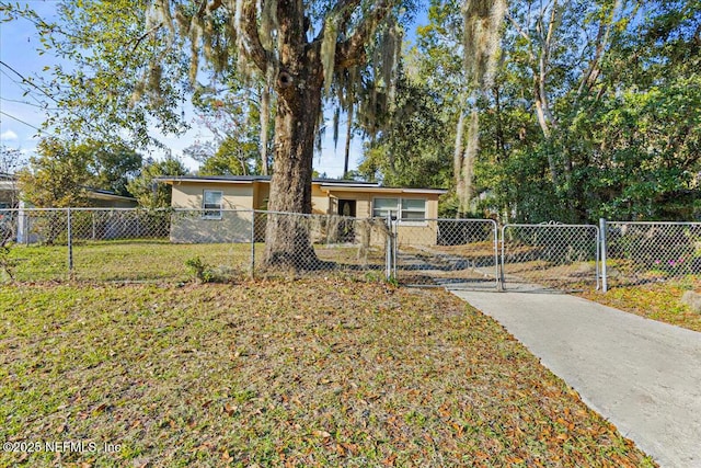 view of front of house with stucco siding, a fenced front yard, a gate, and a front yard