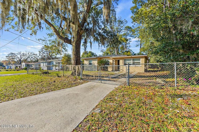 view of front of property featuring a fenced front yard and a gate