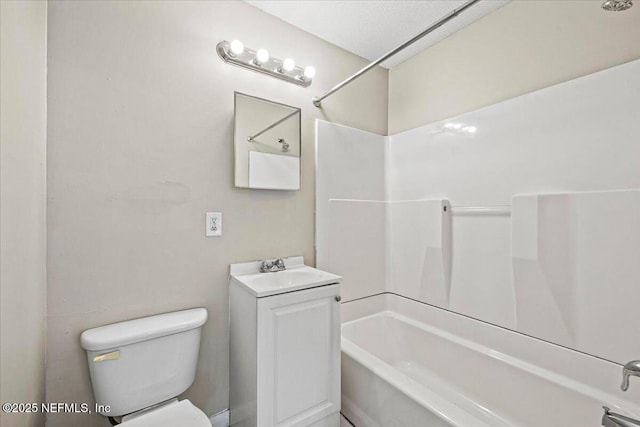 bathroom featuring washtub / shower combination, vanity, and toilet