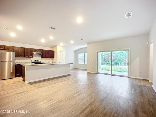 kitchen featuring open floor plan, stainless steel appliances, visible vents, and under cabinet range hood