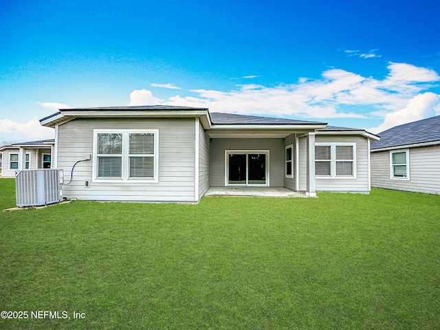 rear view of property with a patio area and a yard