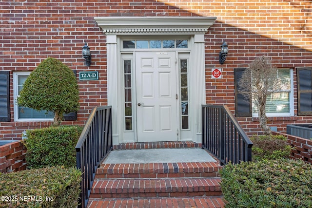 entrance to property with brick siding