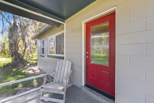 property entrance featuring concrete block siding