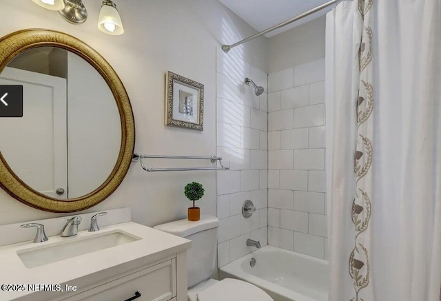 bathroom featuring shower / bath combo, vanity, and toilet