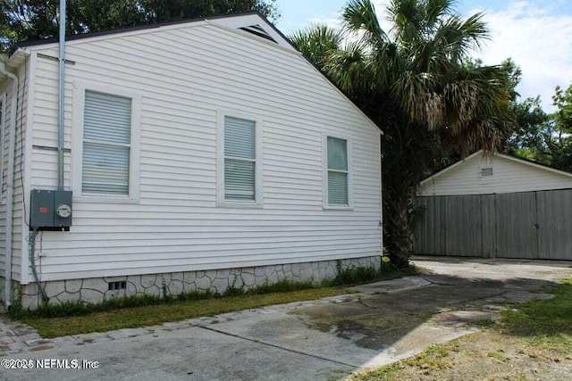 view of property exterior with crawl space and fence