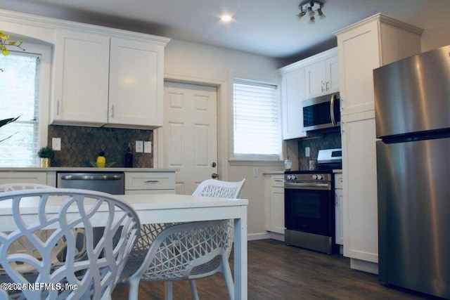 kitchen featuring stainless steel appliances, light countertops, and decorative backsplash