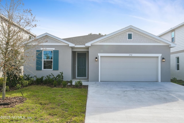 single story home featuring a garage, driveway, roof with shingles, stucco siding, and a front yard