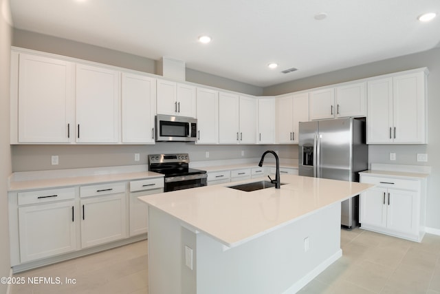 kitchen featuring appliances with stainless steel finishes, light countertops, and white cabinetry