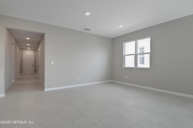 unfurnished room featuring visible vents and baseboards